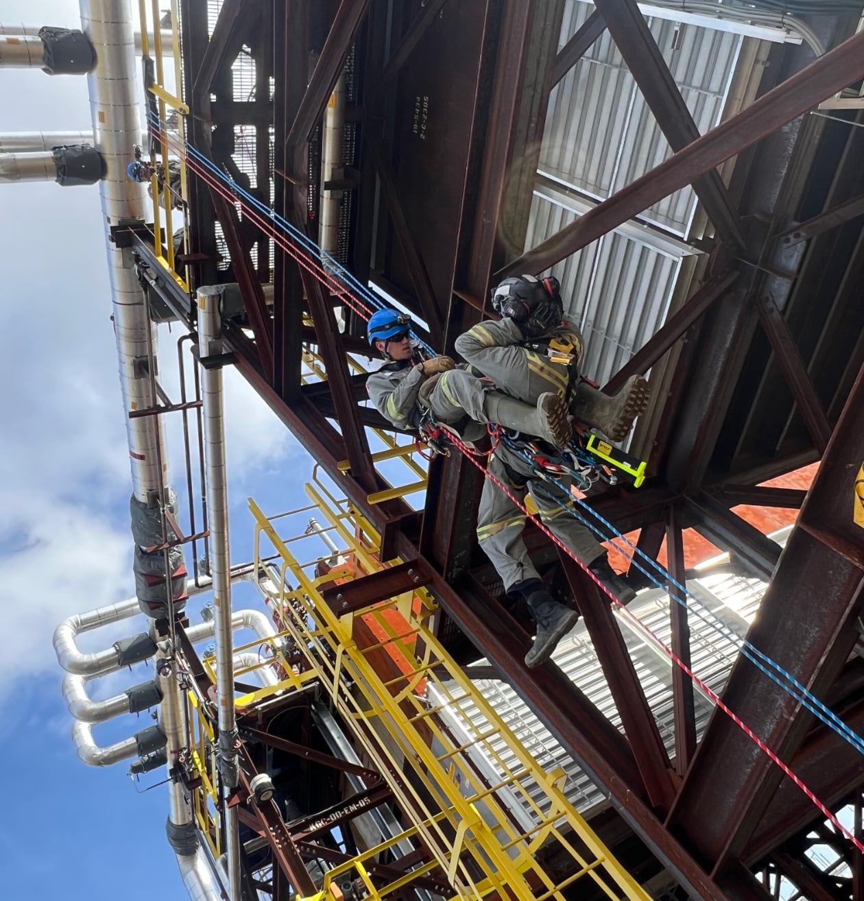Two workers practicing repelling safety training on job site